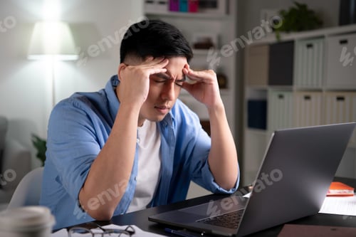 Preview: Stressed Man Working On Laptop At Home