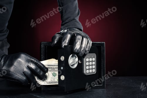 Preview: Close-up view of robber with stealing dollar banknotes from safe