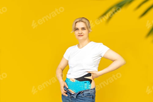 Preview: A woman glues a tape for burning in the abdomen.Relaxation and reduction of pain during menstruation