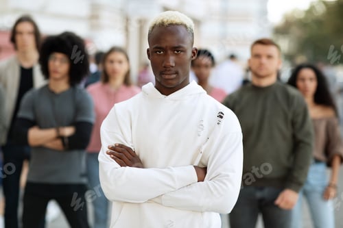 Preview: African american man leader standing over multiracial group of protestors