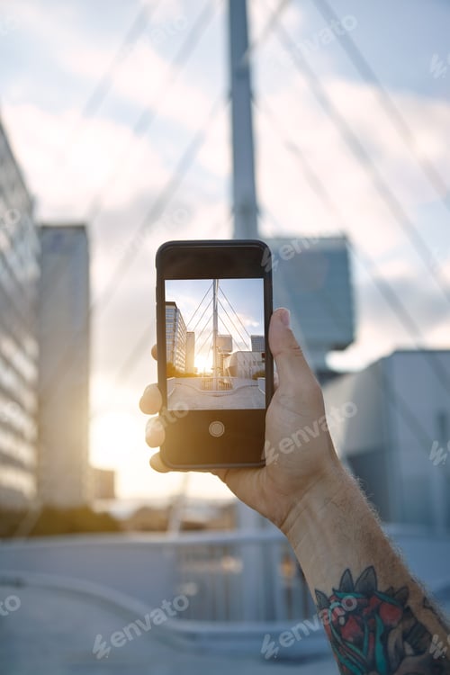 Preview: Taking a photo of city architecture at sunset