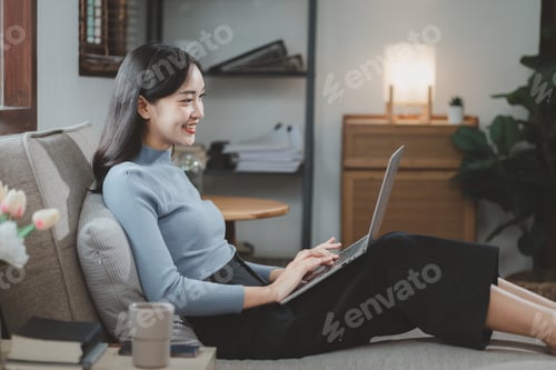 Preview: Woman is sitting and relaxing on the couch, Relax in the living room at home on holiday, Woman using