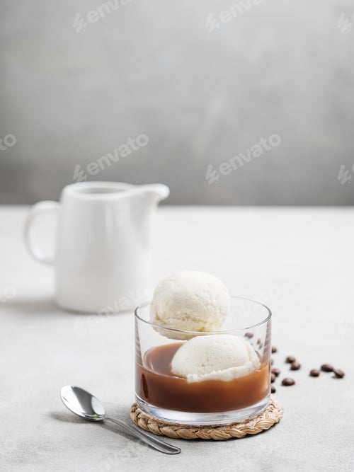 Preview: Affogato coffee with vanilla ice cream scoops and espresso in a glass on a light background