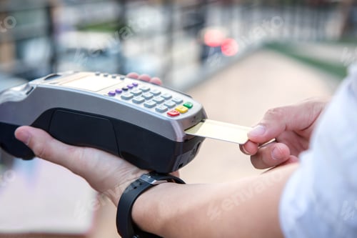 Preview: A payment via credit card swipe machine.