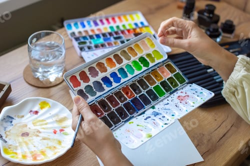 Preview: Watercolor Artist Mixing Paints at Wooden Table