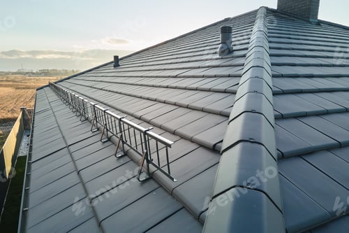 Preview: Closeup of house roof top covered with ceramic shingles. Tiled covering of building