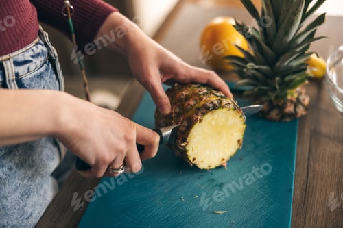 Preview: Woman's Hands Cutting Pineapple