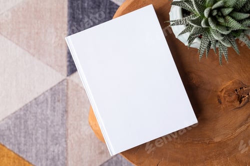 Preview: blank book mockup on coffee table with decorations and colorful rug
