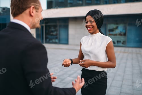 Preview: Business woman and businessman, outdoors meeting