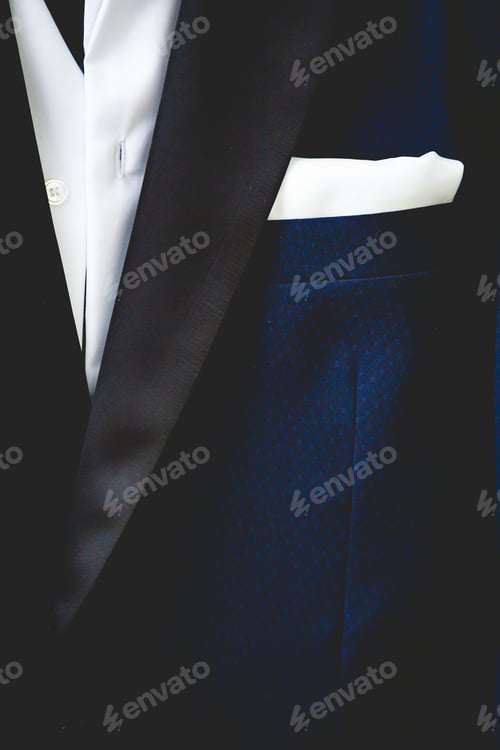 Preview: Vertical closeup shot of a blue man suit with a white shirt and pocket square