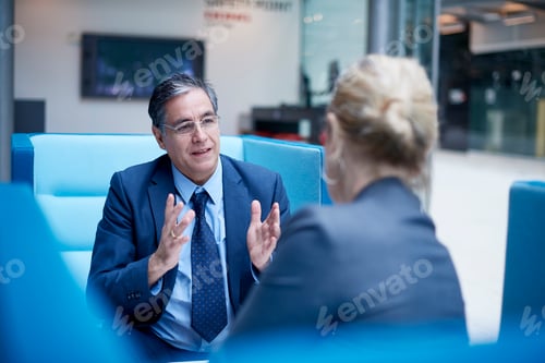 Preview: Businesswoman and man at meeting in office