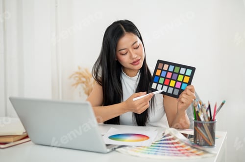 Preview: An asian woman is showing and explaining a color palette to her client or coworker in online meeting
