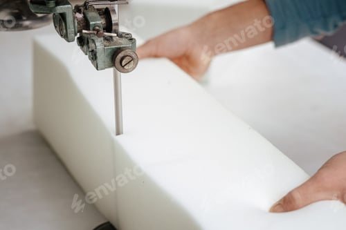 Preview: Closeup of a foam cutter machine, cutting through an upholstery foam