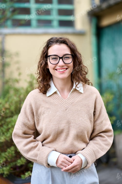 Preview: Young smiling professional business woman standing outdoor, vertical portrait.