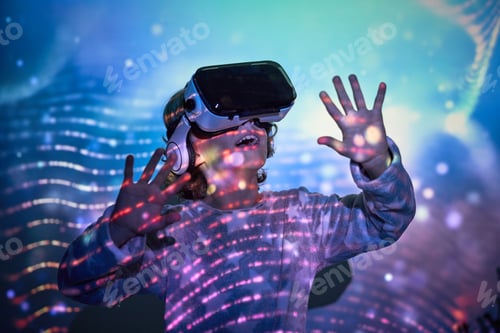 Preview: Amazed smiling child looking up in VR goggles