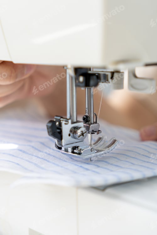 Preview: woman sews clothes on sewing machine. manufacture of dresses, shirts.