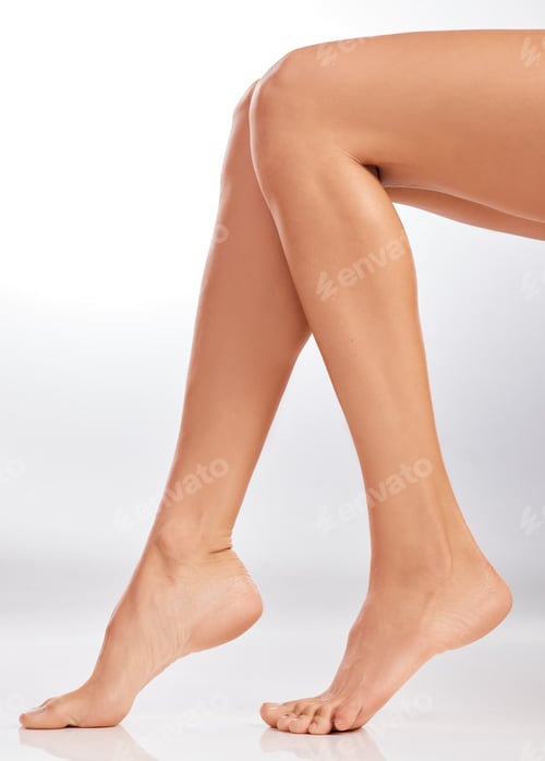 Preview: Cropped shot of an unrecognizable woman sitting alone and showing her legs in the studio