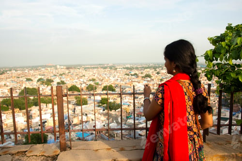 Preview: Portrait of Indian woman against view of Jodhpur the blue city in Rajasthan India