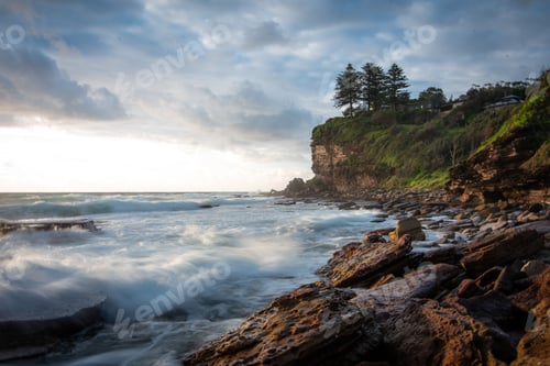 Preview: Waves crashing over rocks along the coastline