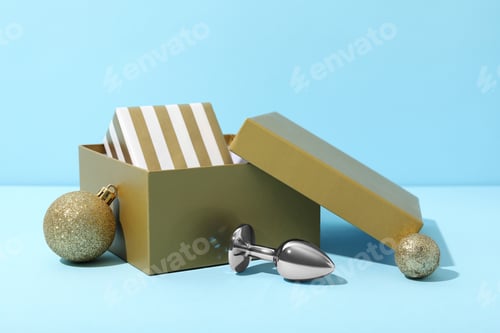 Preview: Metal butt plug with New Year's decor on a blue background.