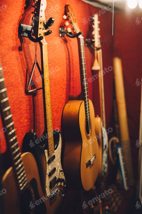 Preview: Electric, acoustic, and bass guitars in a music studio.