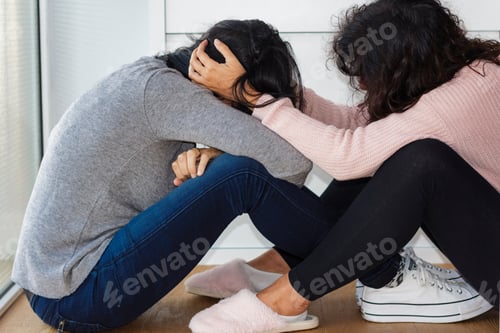 Preview: Woman helping her depressed friend holding her head