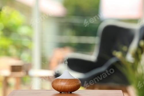 Preview: Aroma oil diffuser lamp on table against blurred background