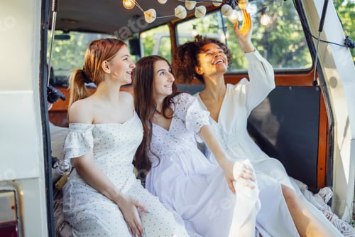 Preview: Pretty smiling three teenage girls in light dresses