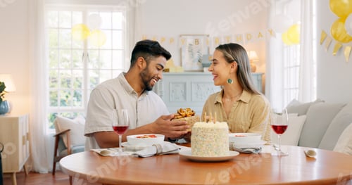 Preview: Interracial, couple and celebrate for birthday with gift, being happy and relax together at party.