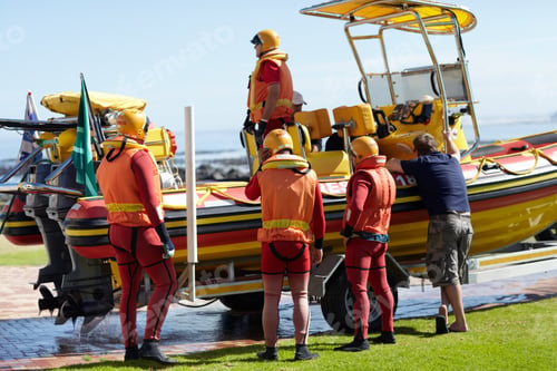 Preview: Full length shot of a group of lifeguards preparing to go out to sea on a rescue mission