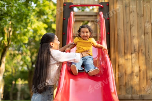 Preview: Happy Japanese Baby Daughter Enjoying Playground Playtime With Mom Outdoors