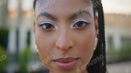 Preview: Gorgeous model looking camera at sunny downtown portrait. Cosmic african woman
