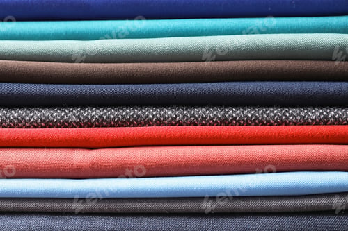 Preview: Stack of colorful fabrics as background