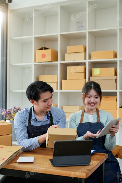 Preview: startup small business owner working with tablet at workplace. freelance man and woman seller check