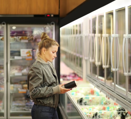 Preview: Woman Choosing Frozen Food From A Supermarket Freezer