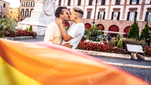 Preview: Gay couple celebrating LGBT pride day - Two homosexual men kissing outdoors