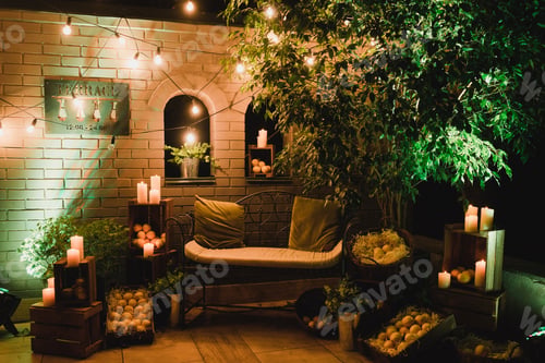 Preview: Lounge and photo zone and traditional European wedding ceremony decoration outdoors in the evening.