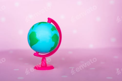 Preview: Small toy globe on a pink background