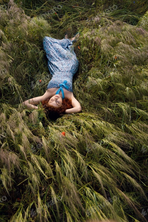 Preview: Beautiful woman sleeping on tall grass