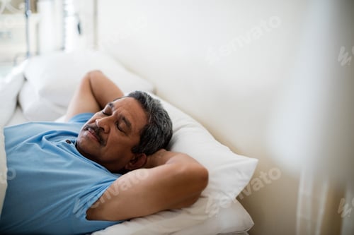 Preview: Senior man sleeping on bed in bedroom