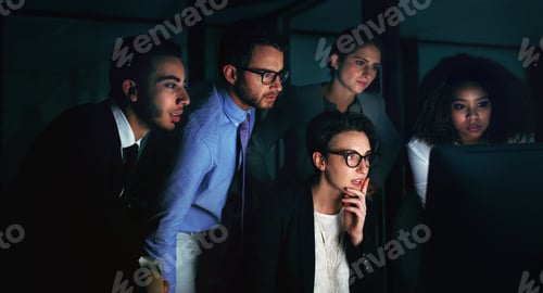 Preview: Cropped shot of a diverse group of businesspeople gathered around a single computer in their office