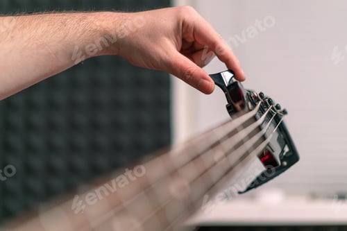 Preview: rock performer with electric guitar recording playing own track tuning musical instrument strings