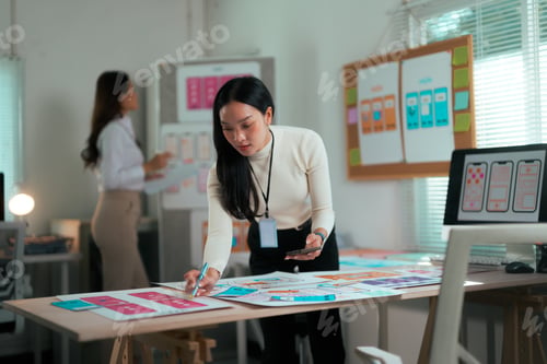 Preview: Asian woman designing mobile application UI UX wireframes