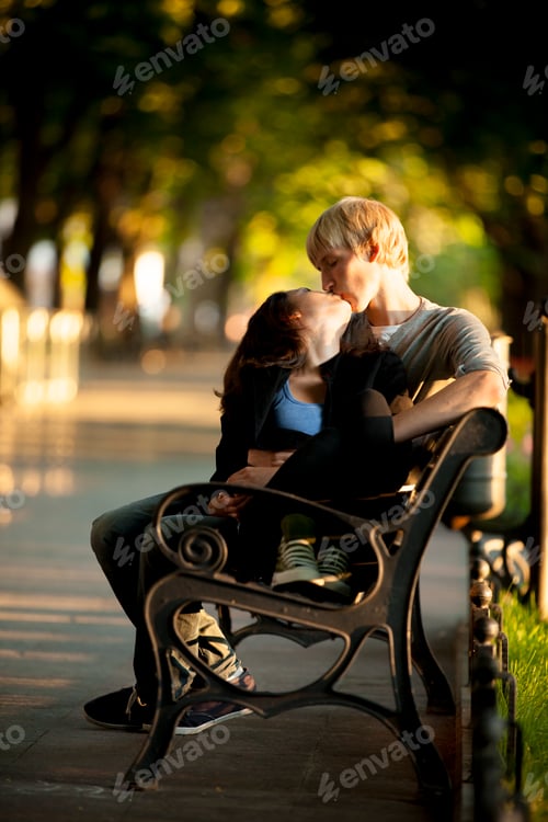 Preview: Young couple on the bench at the street.