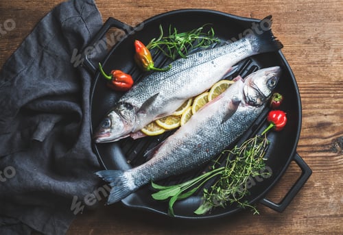 Preview: Raw uncooked seabass fish with lemon slices