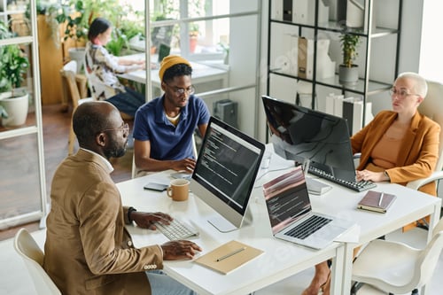 Preview: Programmers working in team at office