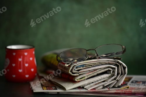 Preview: Cup of coffee and newspaper on a table