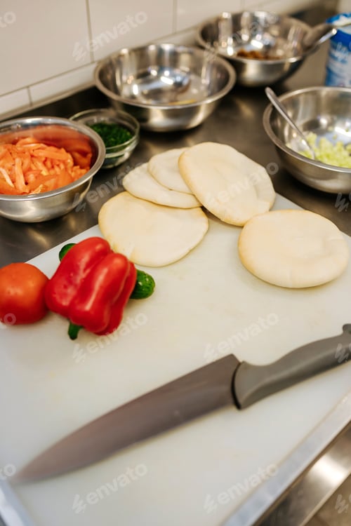 Preview: Cooking in process. Preparing pita with fresh vegetables. Chef in process on the kitchen