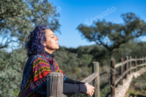 Preview: Mature woman enjoying freedom and nature outdoors