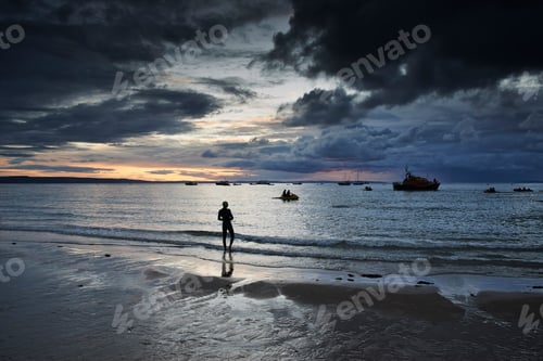 Preview: Swimmer on coastline, Tenby, Wales, UK
